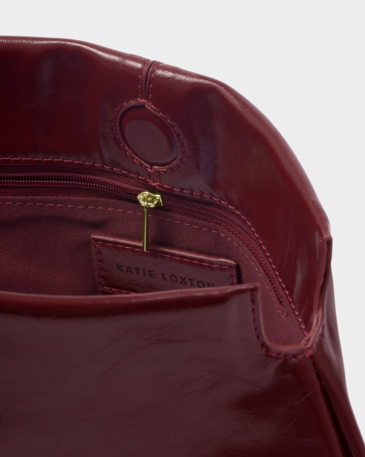 Laila Textured Patent Clutch bag in Cherry
