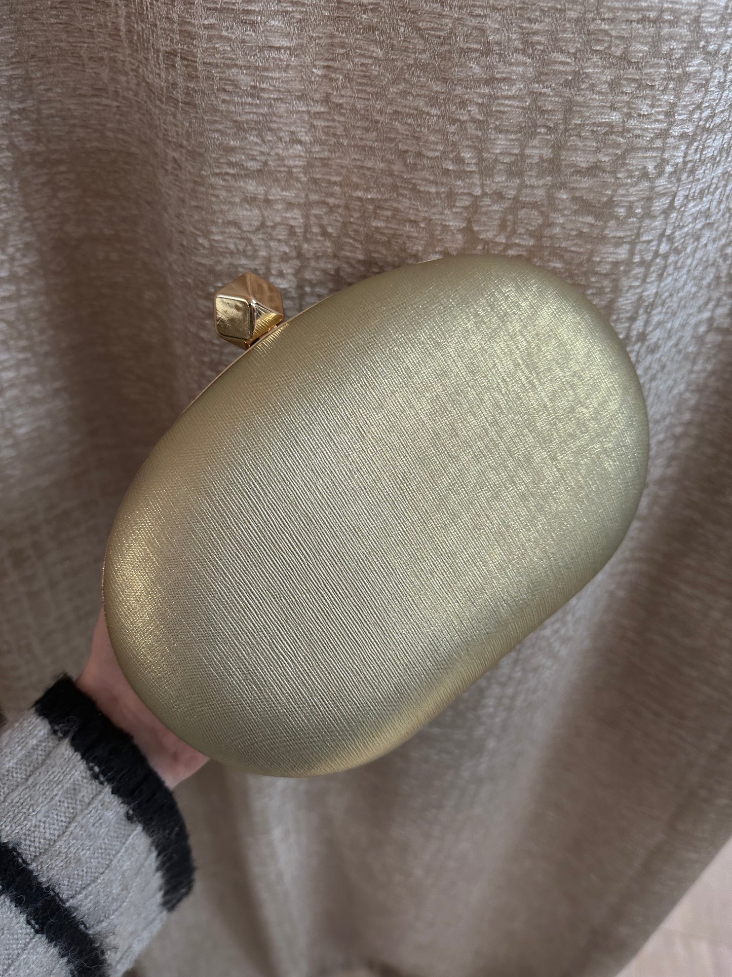 Gold textured clutch bag